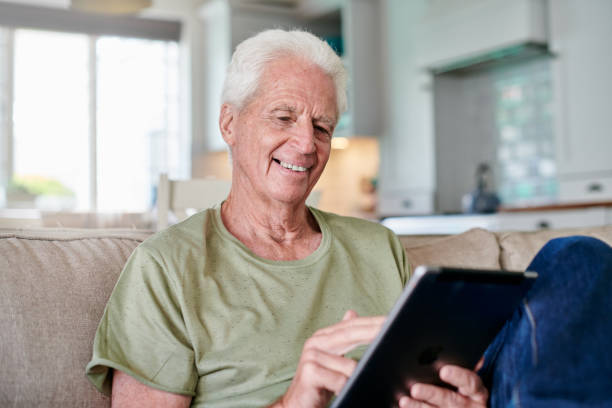 istock Shot of a senior man using a digital tablet while sitting at home 1331997704