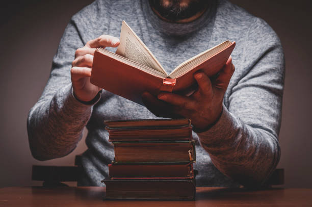 istock Man is Looking or Reading on Old Books 1331998188