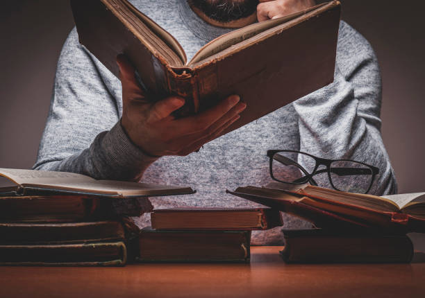 istock Man is Looking or Reading on Old Books 1331998242