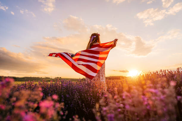 Woman with USA flag in lavender field Young overweight beautiful woman with USA flag in lavender field. american flag flowers stock pictures, royalty-free photos & images