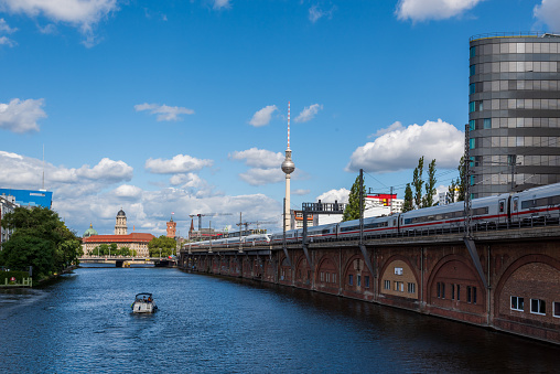 with a view of the television tower, the spree river and a train on a railway bridge