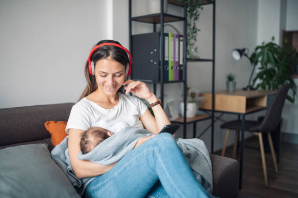 istock Young mother relaxing at home while holding her sleeping baby. 1332008789