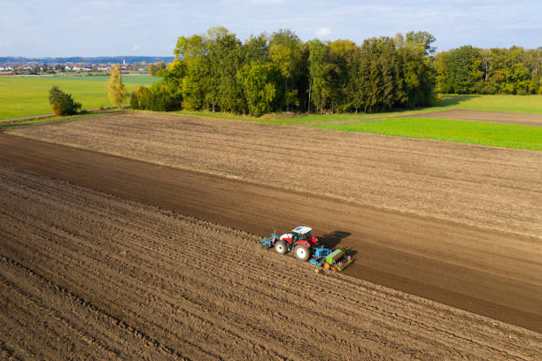 istock Tractor cultivating and sowing field, aerial view 1332009757