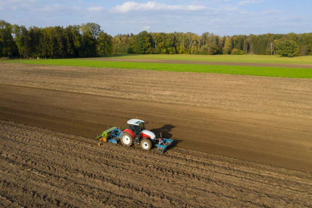 istock Tractor sowing and cultivating field 1332009923