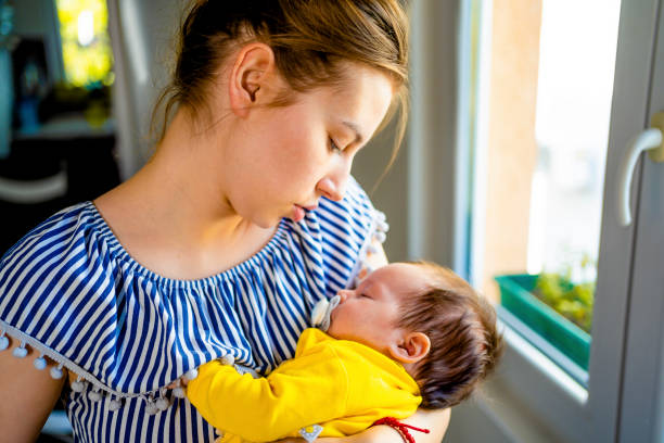 istock Mother with baby in arms 1332010165