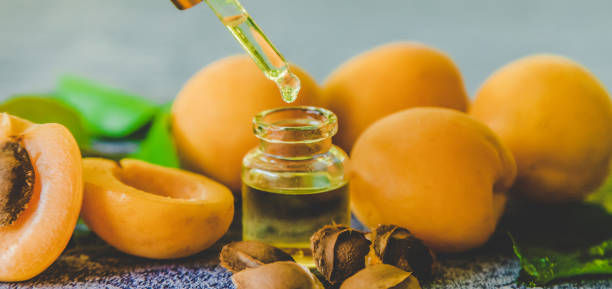 istock Apricot kernel oil in a small bottle. Selective focus. 1332010177