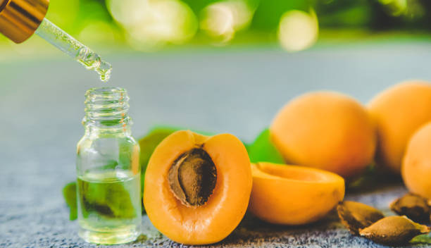 istock Apricot kernel oil in a small bottle. Selective focus. 1332010178