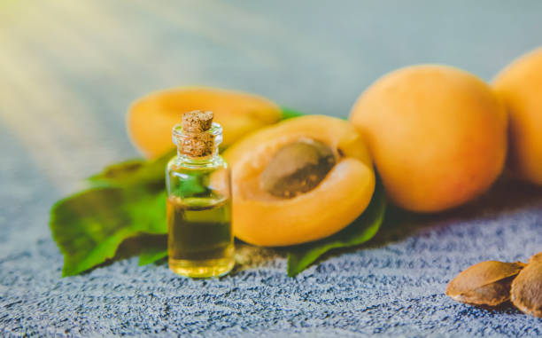 istock Apricot kernel oil in a small bottle. Selective focus. 1332010187