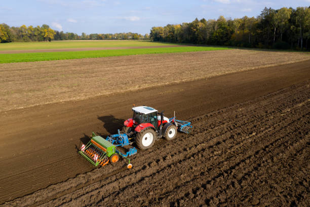 istock Tractor sowing and cultivating field 1332010188