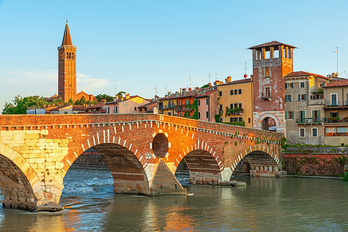 View on Bridge Ponte Pietra in Verona on Adige river, Veneto region, Italy. Summer morning landscape. Travel destination