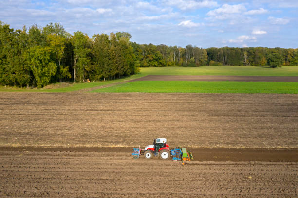 istock Tractor sowing and cultivating field 1332010843