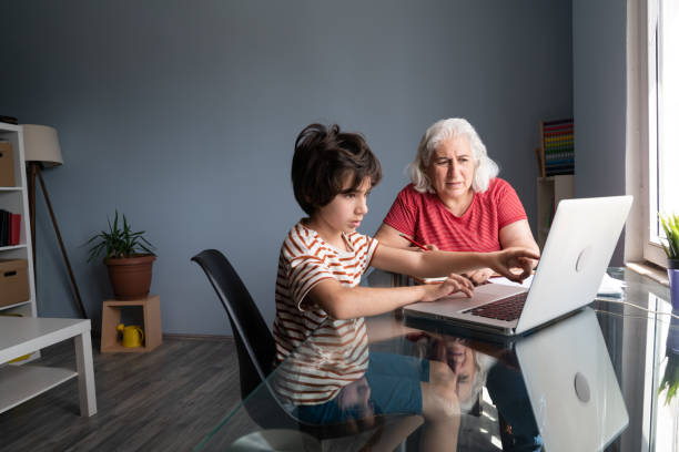 istock Senior Grandmother And Grandson Using Laptop Computer At Home 1332010928
