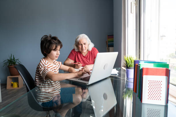 istock Senior Grandmother And Grandson Using Laptop Computer At Home 1332010995