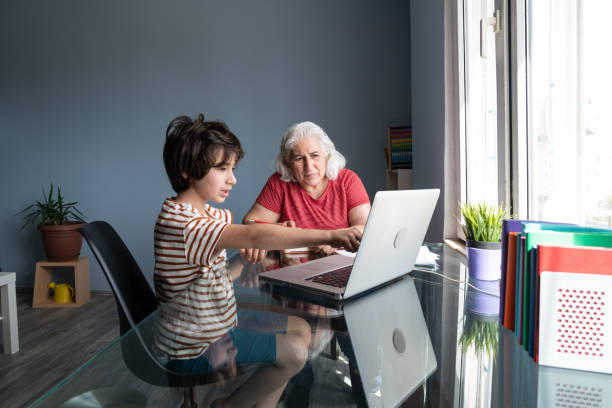 istock Senior Grandmother And Grandson Using Laptop Computer At Home 1332011046