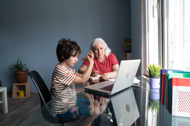 istock Senior Grandmother And Grandson Using Laptop Computer At Home 1332011106