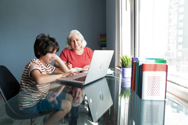 istock Senior Grandmother And Grandson Using Laptop Computer At Home 1332011147