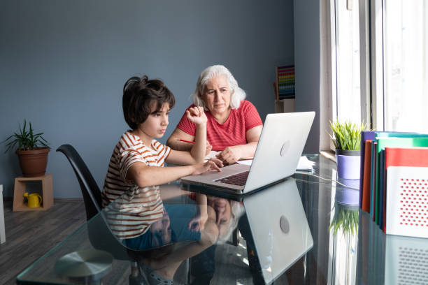 istock Senior Grandmother And Grandson Using Laptop Computer At Home 1332011150