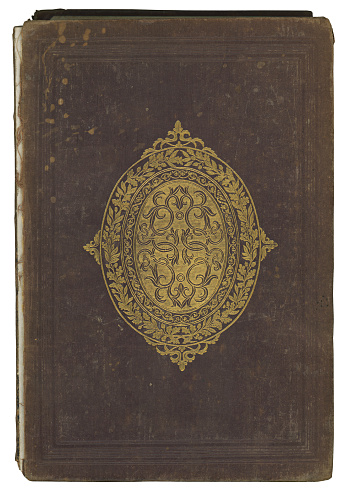 Antique brown hardcover book with an ornate design.