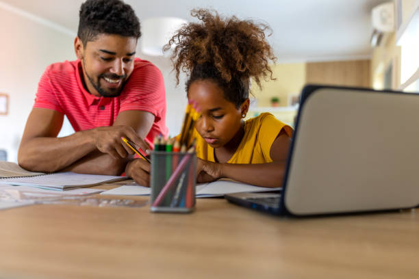 istock Happy child girl involved in doing task, studying homeschooling with father. 1332014734