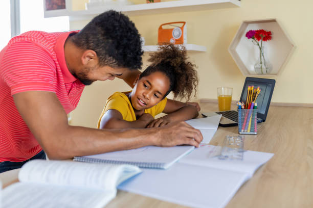 istock Happy child girl involved in doing task, studying homeschooling with father. 1332014737