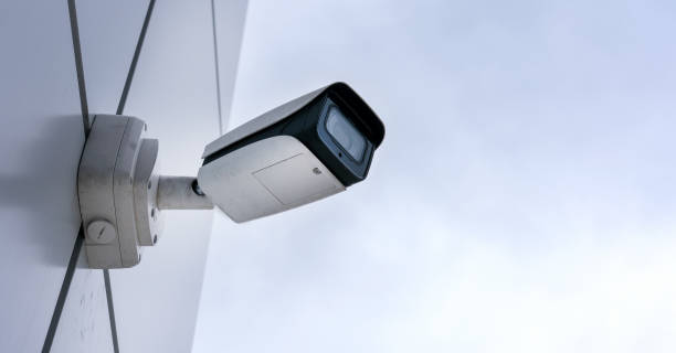 istock black and white surveillance camera located on building wall 1332016642
