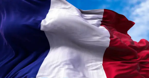 Photo of Detail of the national flag of France flying in the wind