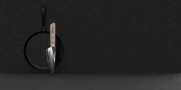 Chef's knife and working equipment concept: Professional sharp cutting knife for cooking. Kitchen utensils for the food and drink industry. Useful add with kitchenware for hotel and restaurant business on black background with large copy space.