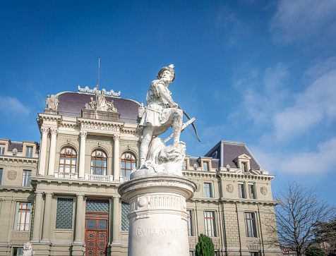 Lausanne, Switzerland - Dec 04, 2019: William Tell Statue in front of Palace of Justice Building - Lausanne, Switzerland
