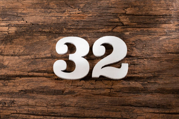 istock thirty two 32 - White wooden number on rustic background 1332021796