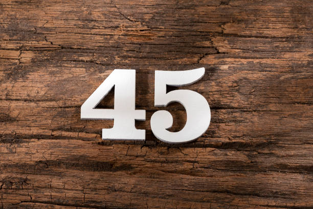 istock Number forty five 45 - White Piece on Rustic Wood Background 1332022372