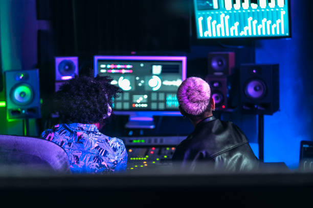istock Young audio engineer people having fun working with mixer sound panel control in music recording studio 1332022433