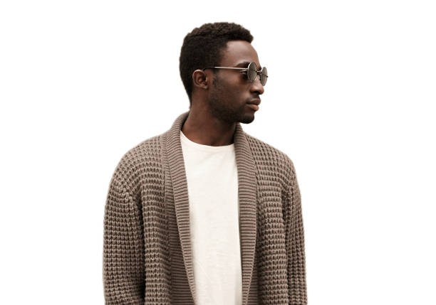 Portrait of stylish young african man model wearing a knitted cardigan isolated on a white background stock photo