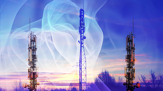 Abstract radio waves radiate from the modern cellular communication towers against the backdrop of nature. . Double exposure.