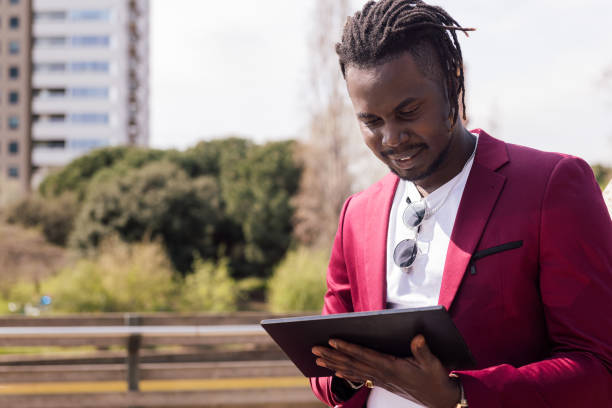 istock african man using a tablet outdoors in the city 1332032957