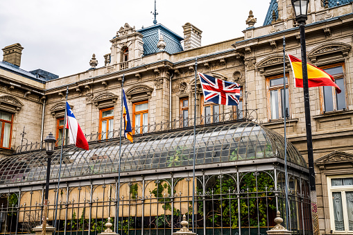 Palacio Sara Braun Palace Chilean International Flags Punta Arenas Chile.  Palace built in late 1800s, located central square downtown Punta Arenas