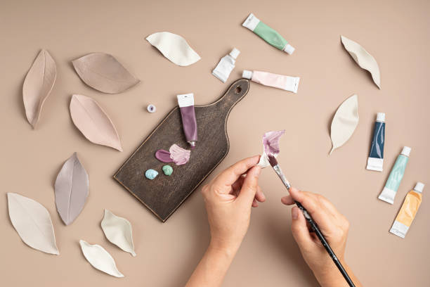 istock Hobby background with handmade clay leaves, paint brushes and art accessories 1332033342