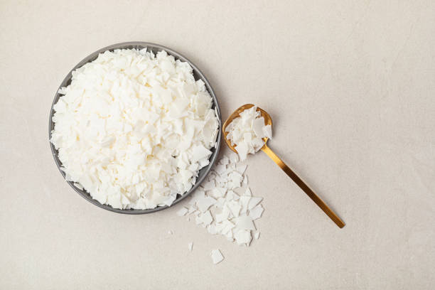Flatlay with organic white soy wax flakes. Handmade candles, diy, hobby idea Flatlay with organic white soy wax flakes. Handmade candles, diy, hobby concept. Flat lay, top view candle wax stock pictures, royalty-free photos & images