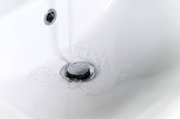 istock modern metal faucet Kitchen sink with running water 1332034556