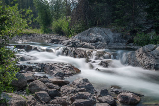istock Cascading water in cool mountain river 1332047436