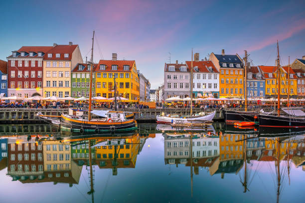 Copenhagen city skyline in Denmark at famous old Nyhavn port Cityscape of downtown Copenhagen city skyline in Denmark at famous old Nyhavn port at sunset nyhavn stock pictures, royalty-free photos & images