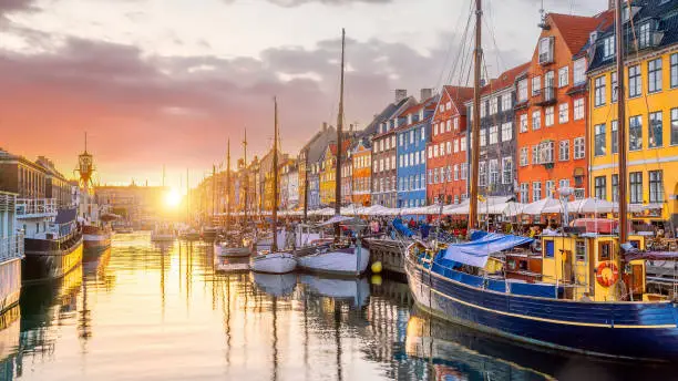 Cityscape of downtown Copenhagen city skyline in Denmark at famous old Nyhavn port at sunset