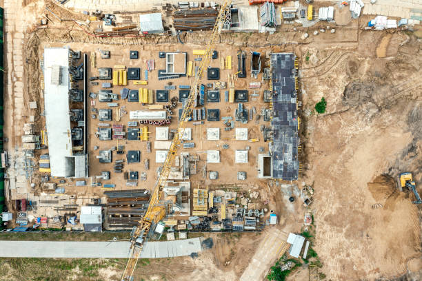 istock multilevel parking garage under construction. building the foundations on the construction site with a yellow crane. aerial top view 1332053638