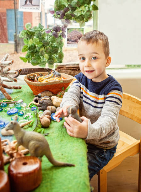 child playing with toy animals
