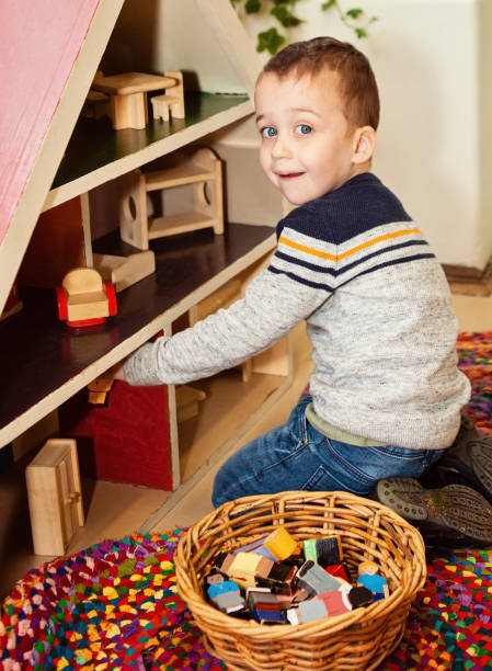 istock young child playing with a dolls house 1332056020