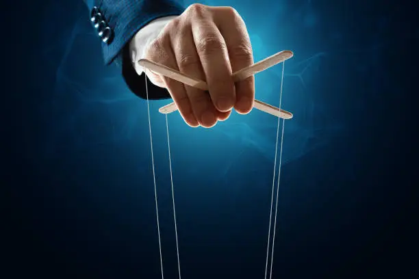 Photo of The puppeteer's hand is large. The concept of world conspiracy, world government, manipulation, world control.