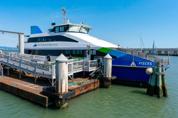 San Francisco Bay Ferry boat Pisces docked at Oracle Park terminal. San Francisco Bay Ferry is a public transit passenger ferry service San Francisco Bay Ferry boat Pisces docked at Oracle Park terminal. San Francisco Bay Ferry is a public transit passenger ferry service - San Francisco, California, USA - 2021 san francisco bay stock pictures, royalty-free photos & images