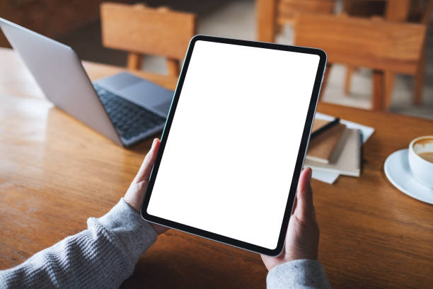 istock a woman holding digital tablet with blank white desktop screen 1332062254