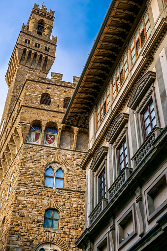 The splendid façade of Palazzo Vecchio with the Arnolfo Tower and a portion of the Uffizi Gallery, in the historic and medieval heart of Florence, in Tuscany. Palazzo Vecchio, built between 1299 and 1314 as the seat of the Priors of the Arts, the representatives of the professional guilds that governed the medieval city, was transformed from 1540 into the seat and symbol of the Medici family's rule by Grand Duke Cosimo I. Even today it is the seat of the Municipality of Florence (Town Hall) and of the city government. The Uffizi Gallery is one of the most important museums in the world. Built between 1560 and 1581 at the behest of the Medici family to house the new offices (Uffizi) of the Florentine government, the Uffizi building now houses one of the greatest artistic heritages in the world, with works of art by Leonardo da Vinci, Raphael, Sandro Botticelli, Titian, Pontormo, Bronzino, Giotto di Bondone, Caravaggio, Dürer, Rubens, among others. Since 1982 the historic center of Florence has been declared a World Heritage Site by Unesco. Image in high definition format.