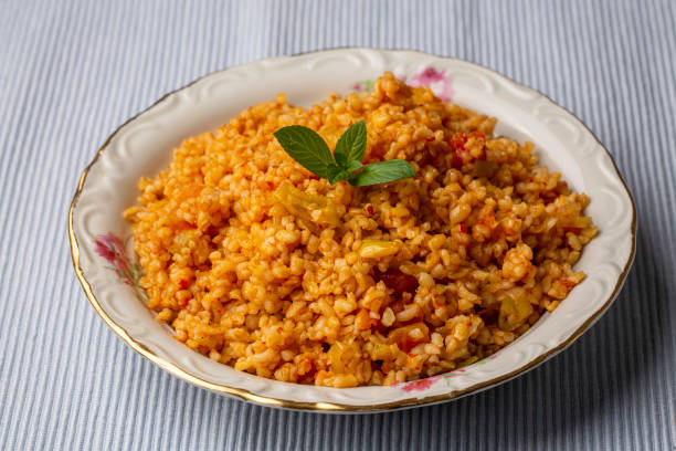 istock Traditional turkish bulgur pilaf with tomato sause in plate (Turkish name; meyhane pilavi) 1332068611