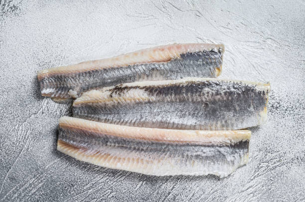 istock Pickled marinated sea herring fillet. White background. Top view 1332069722